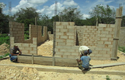 Workmen were building forms for concrete columns across the street