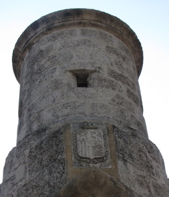 The tower, part of the old wall, has the Spanish crest on it.