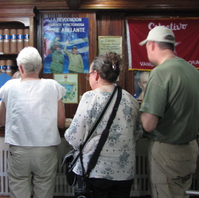 Patti, Renee and Doug investigating the cigar selections
