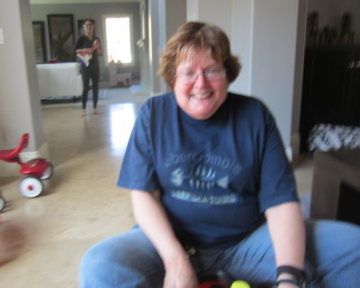 Back inside the house, Grandma took a ride on one of the kids indoor vehicles.