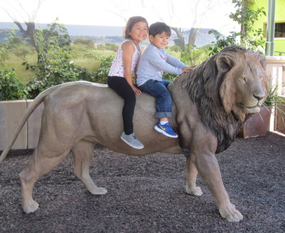 Brave Devon and Zeke ride the lion by themselves.