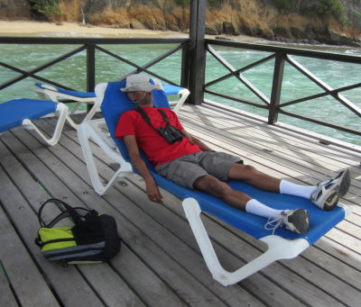 Kannan relaxes on the dock while we wait for our boat