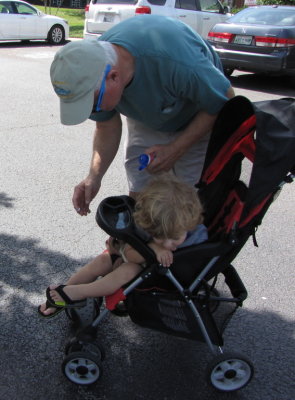 Grandpa tries to apply a little sunscreen to Max's nose; Max is not interested.