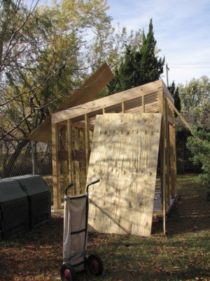 Last night, I managed to get the very heavy 3/4 (11/32) treated plywood from the pickup to the backyard using a two-wheel cart. Then I tried lifting and pushing a piece up onto the roof from the back (shortest) side. I managed to get my head out from between it and the top of the fence, but it got caught in the chain links and the horizontal fence section and I couldn't get enough leverage from below to get it free, so I left it sticking in the air over night.