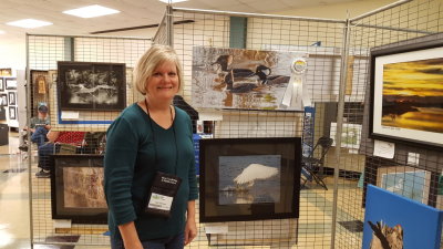 Our friend Jan entered the festival art contest and won third place on her first try with a photo of Hooded Mergansers printed on canvas.