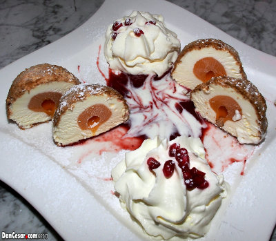 Tichy apricot ice cream dumplings with strawberry sauce and whip cream 