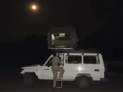 Climbing up to our sweet car-top tent!