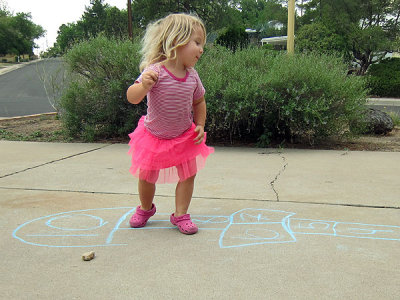 Annie learns to play hopscotch