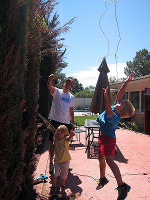 Simon works hard to rope the treetop