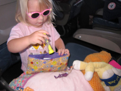 Annie unpacks her travel gear on the plane