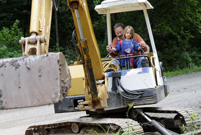 How is this little girl driving this giant excavator?