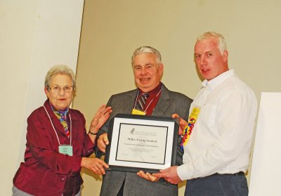 Fenya presents conservation award to representatives from Miller Paving