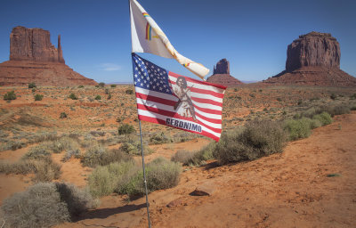 The Navajo Flag Flies Above A Flag Honoring Geronimo At Monument Valley