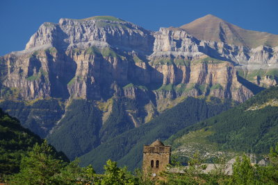 The massive escarpment of the Pyrenees - and Monte Perdido Nat'l Park - looms behind the town of Broto, Spain. July 18, 2016. 