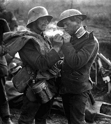 German giving British prisoner a light
