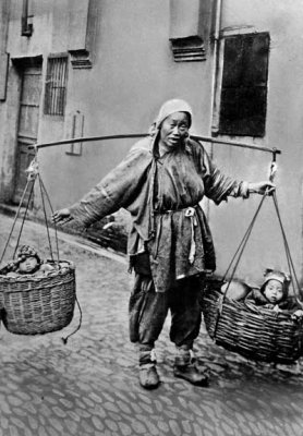 c. 1915 - Beggar with babies in baskets