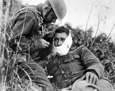 September 1918 - Receiving first-aid treatment from a comrade