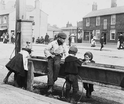 c. 1900 - Playing at a water trough, Barnet High Street