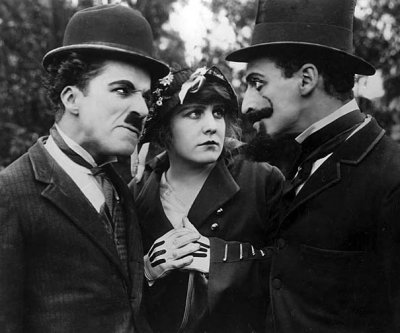 1915 - Charlie Chaplin, Edna Purviance, and Leo White