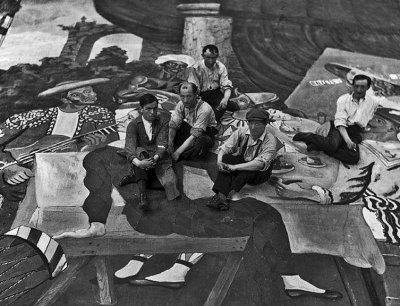 1917 - Picasso (in cap) and scene painters sitting on the front cloth of Parade