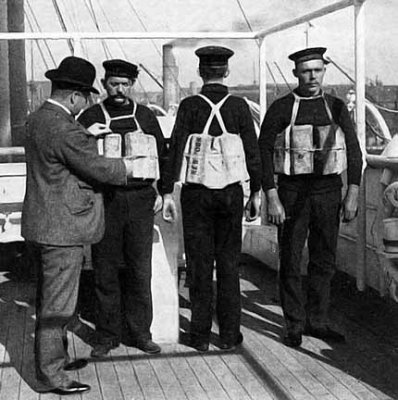 1912 - Examining life jackets aboard ship