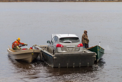 Vehicle headed to Moose Factory from Moosonee on a small barge.