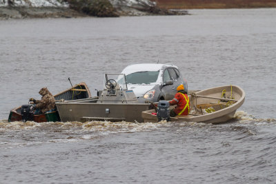 Vehicle headed to Moose Factory from Moosonee on small barge.