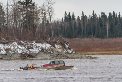 Vehicle being carried to Moose Factory on small barge.