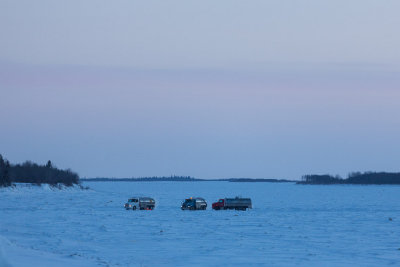 Winter road water tankers filling up on the Moose River.