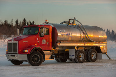 Winter road water tanker filling up on the Moose River at Moosonee.
