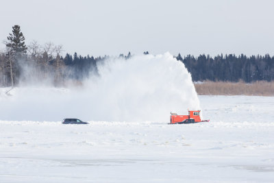 Snow blower on winter road on the Moose River.