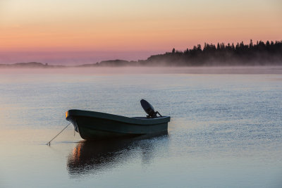 Canoe on the Moose River on a foggy morning around sunrise.