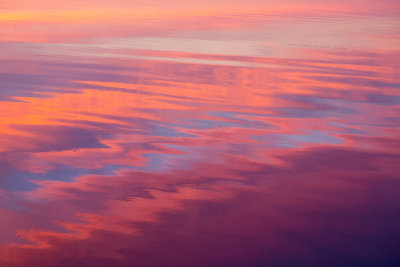 Surface of the Moose River reflecting clouds before sunrise.