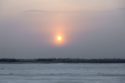 Sun cuts through the clouds over the Moose River.
