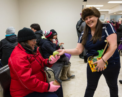 Ticket agent June Miller distributing oranges