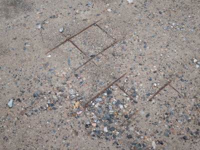 Sidewalk reinforcing steel showing through