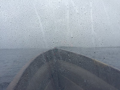 View through front window of a taxi boat on a rainy afternoon.