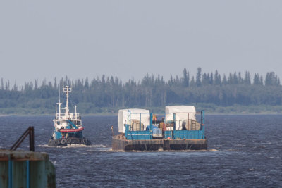 Tug Nelson River and barge head down the Moose River towards James Bay.