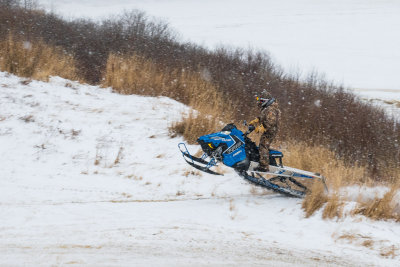 Snowmobile climbing McCauley's Hill in Moosonee.