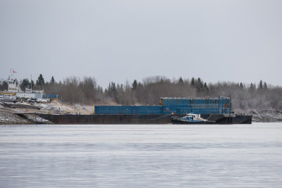 Small tug Harricana River and barges on the Moose River at Moosonee 2016 May 15th