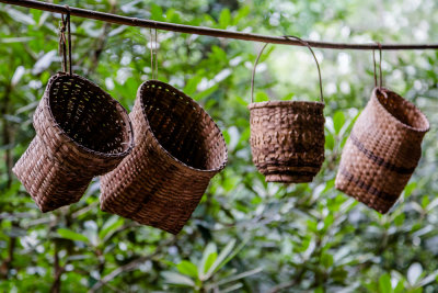 Baskets hang in the weaver's shop.