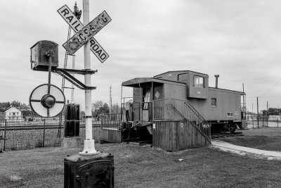 Caboose by a warning sign