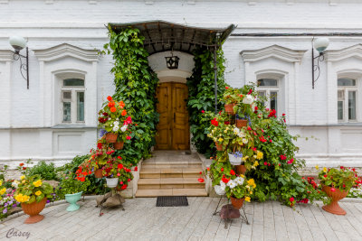 Flowers adorn the entrance to a building.
