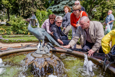 These folks were fascinated by this Peacock.