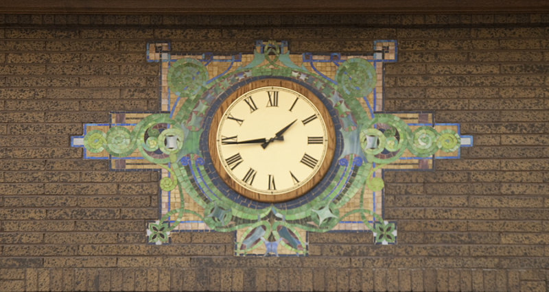 Clock with tile pattern below rose window