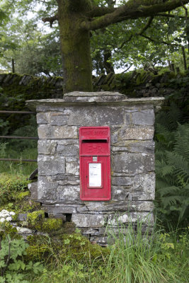 Outgate: Mailbox built into fence wall