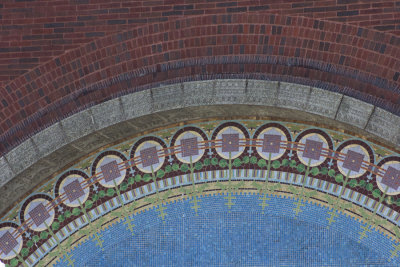 Geometric border of mosaic half-round above front door