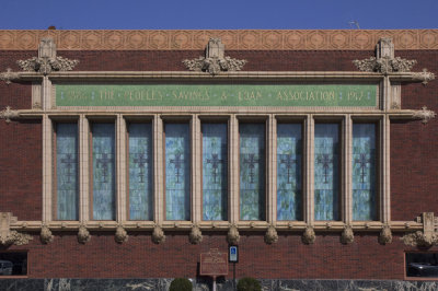 Side façade with stained glass windows bordered with terra cotta