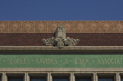Terra cotta ornament above mosaic building title