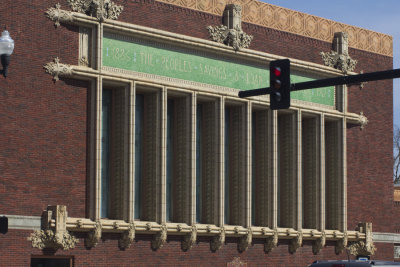 Side façade with stained glass windows bordered with terra cotta